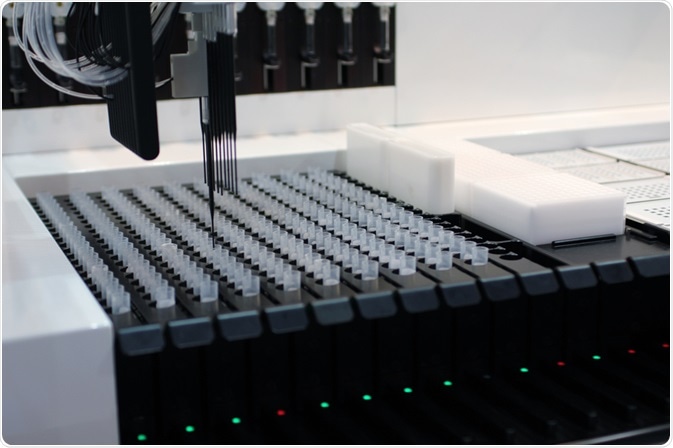 Liquid handling robots are automated devices that dispense and sample liquids in laboratory settings. In this example, a robot is picking up pipette tips.