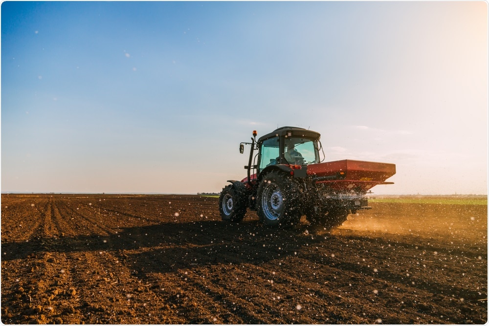 Farmer fertilizing land Farmer fertilizing land