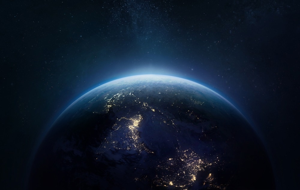 Nightly Earth planet in outer space. City lights on planet.