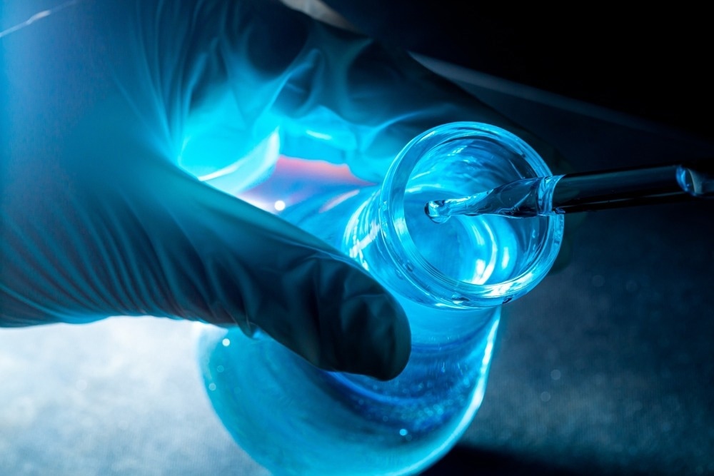 Blue science experiment glass tube,Researchers with chemistry test tubes in a liquid glass lab for analytical, medical, pharmaceutical and scientific research concepts
