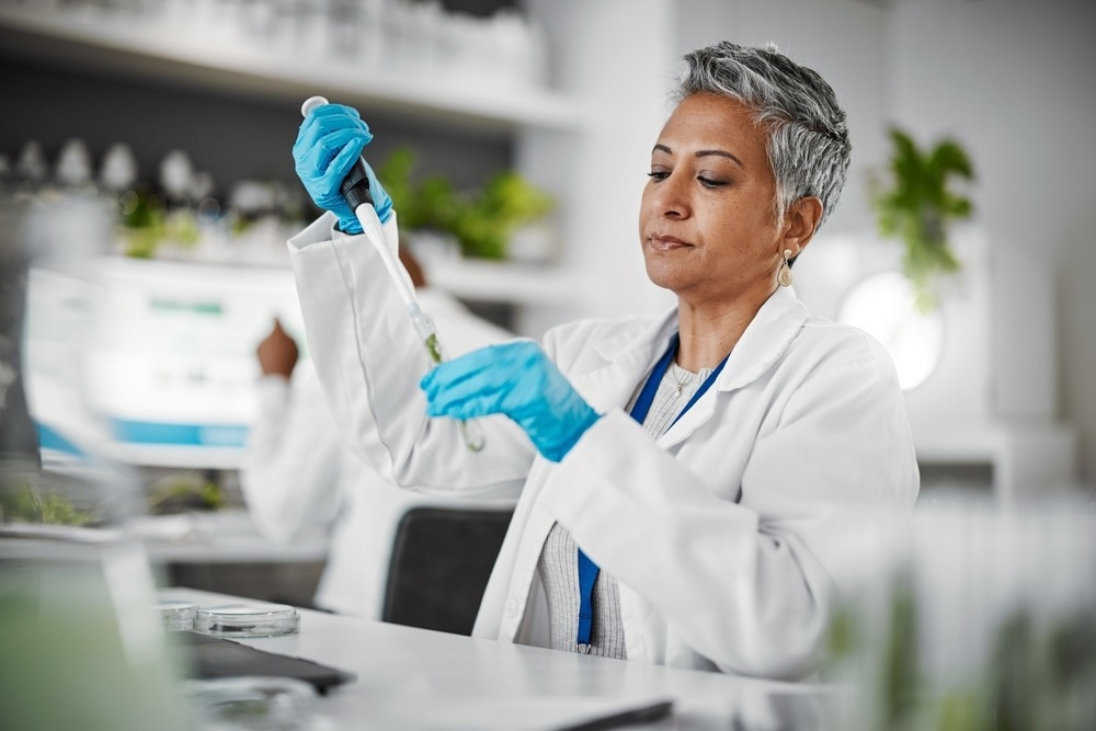 Plants, test tube and science woman with research, exam and solution for leaves in laboratory, eco friendly medicine.