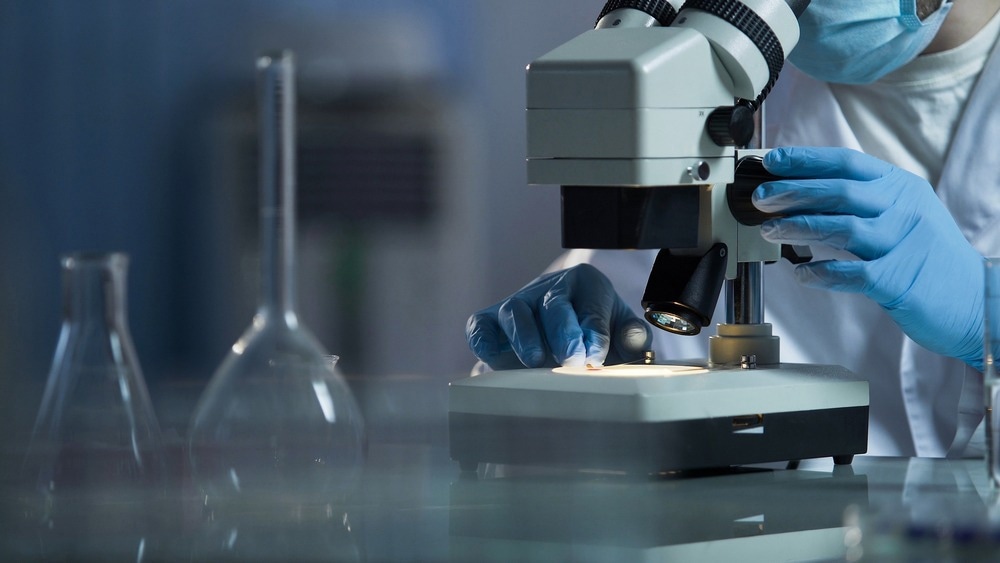 Scientific lab expert examining new substance for skin care cosmetics, science
