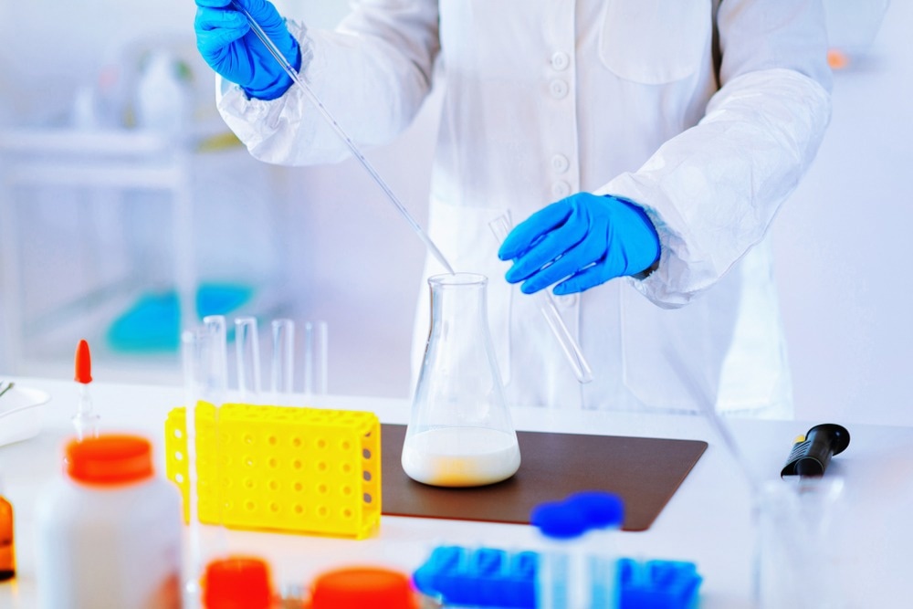 Quality control expert inspecting milk in the laboratory
