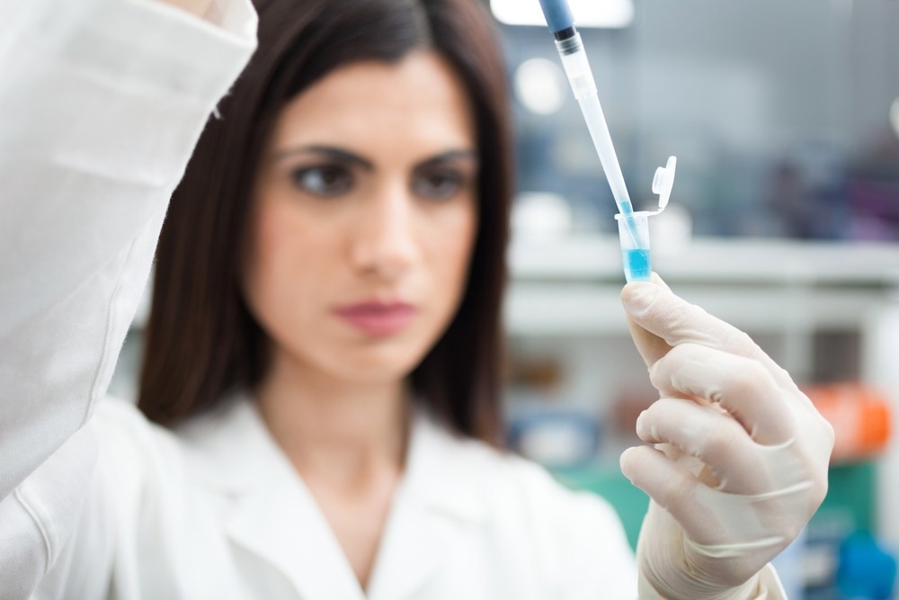 Scientist putting a sample in a test tube in a chemical laboratory