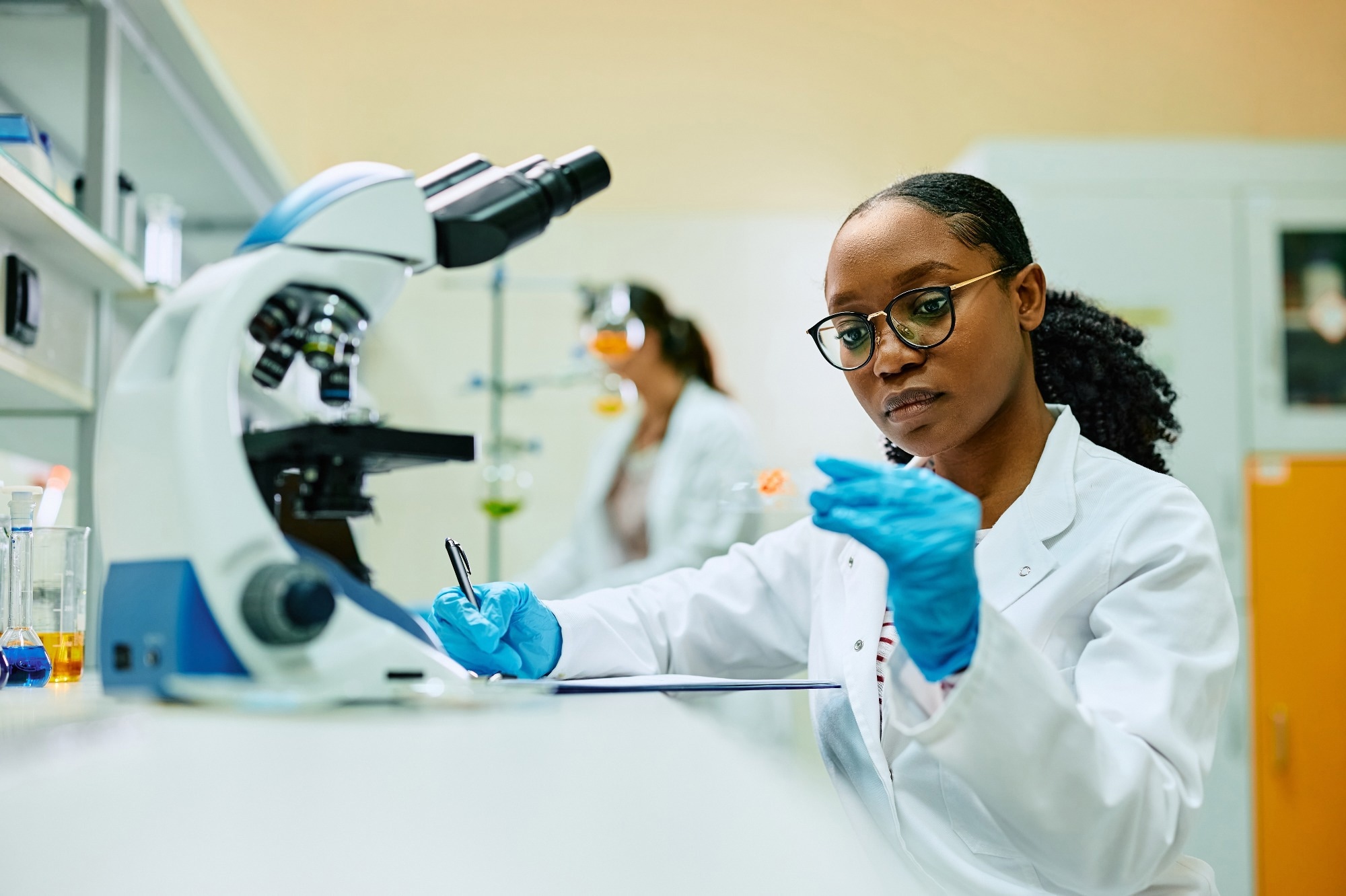 Forensic Scientist using Microscope