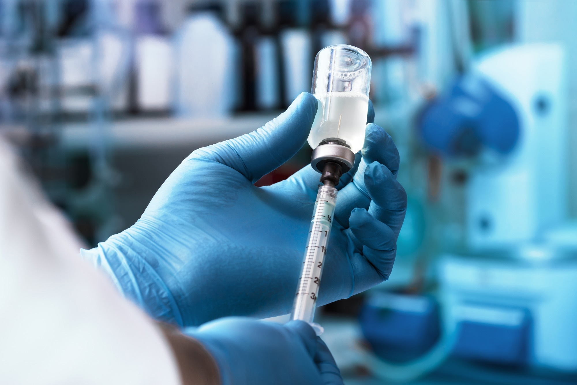 Physician filling syringe with dose of vaccine.