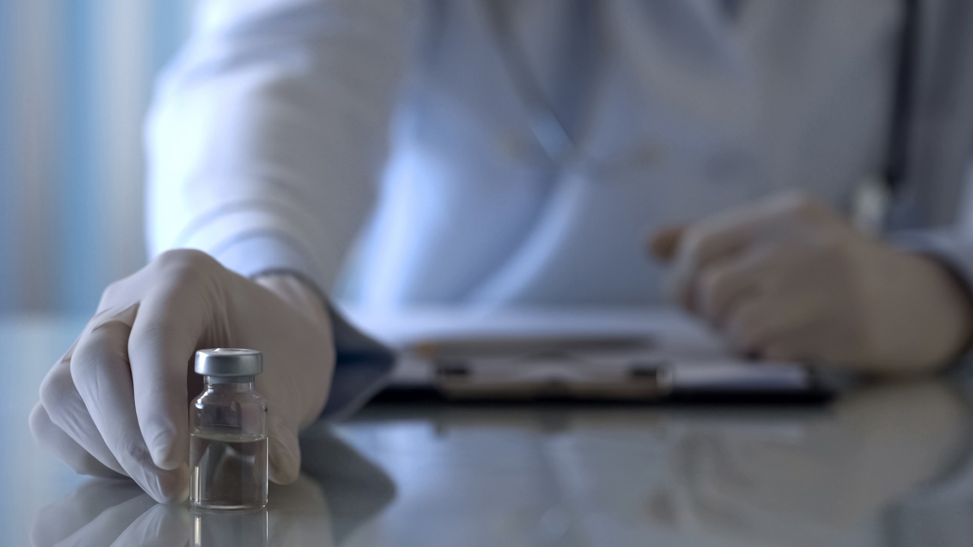 Immunologist holding bottle with medication