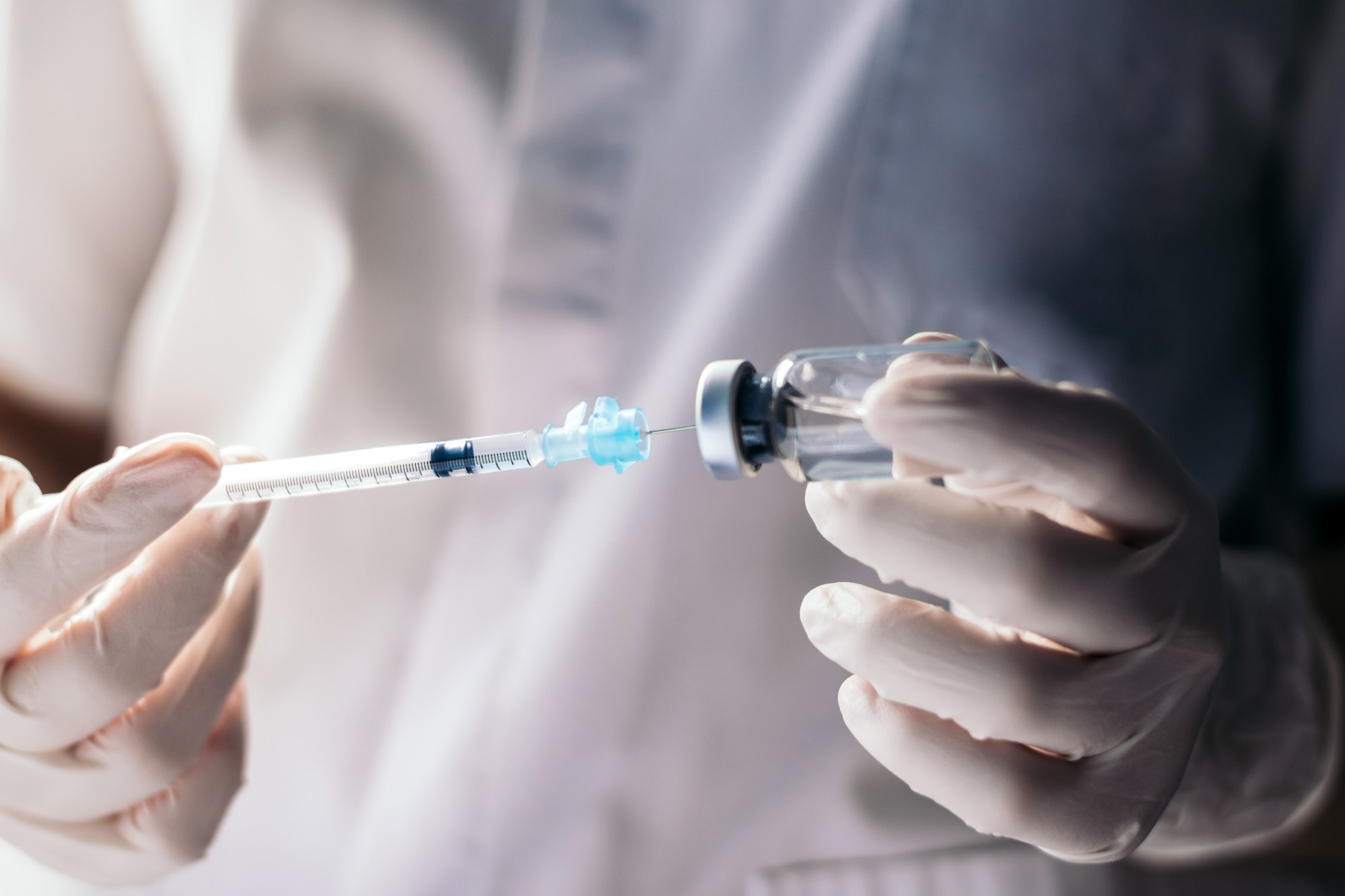 doctor or nurse putting vaccine in vial