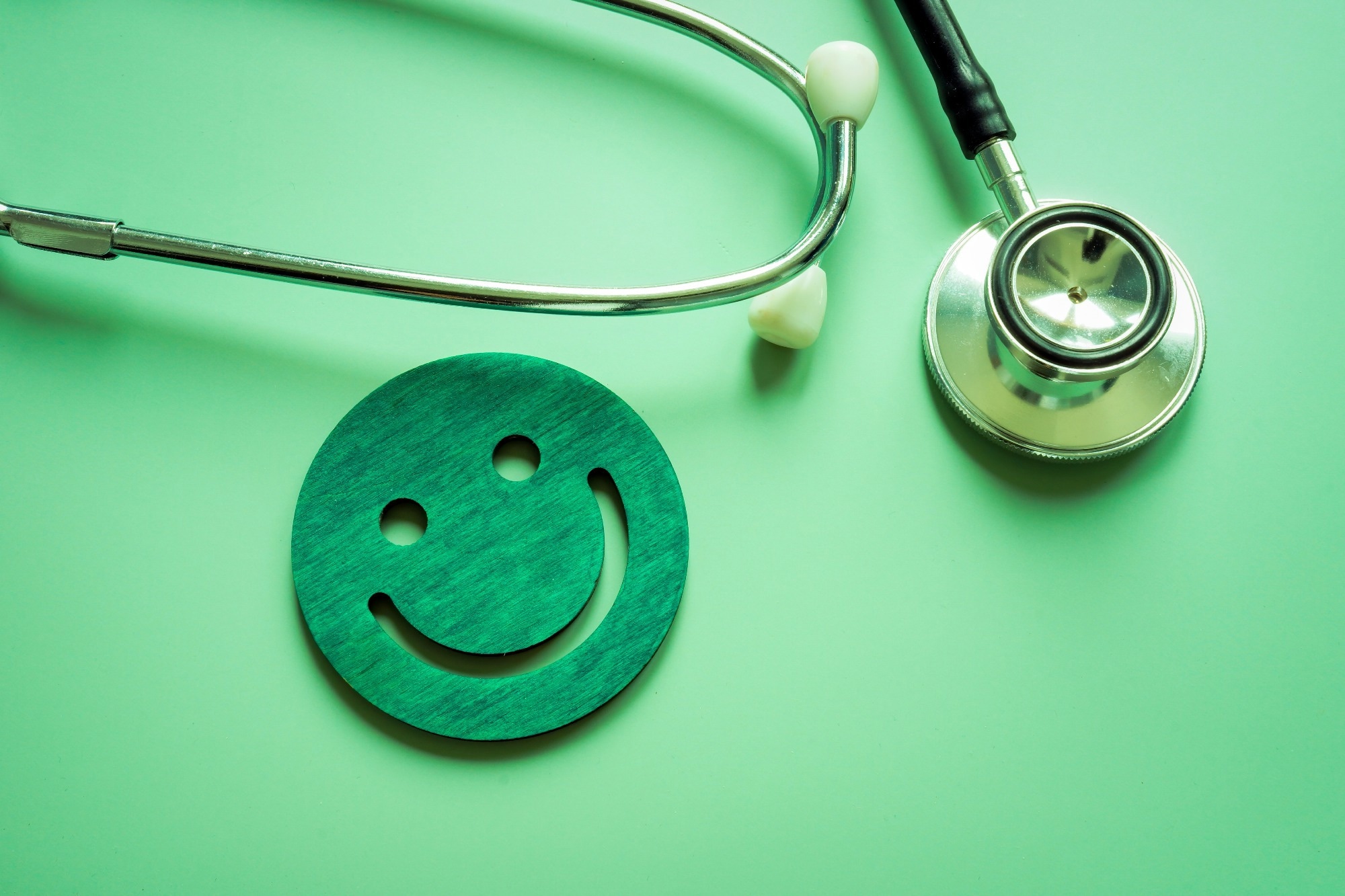 Stethoscope and smile face as good assessment of health.