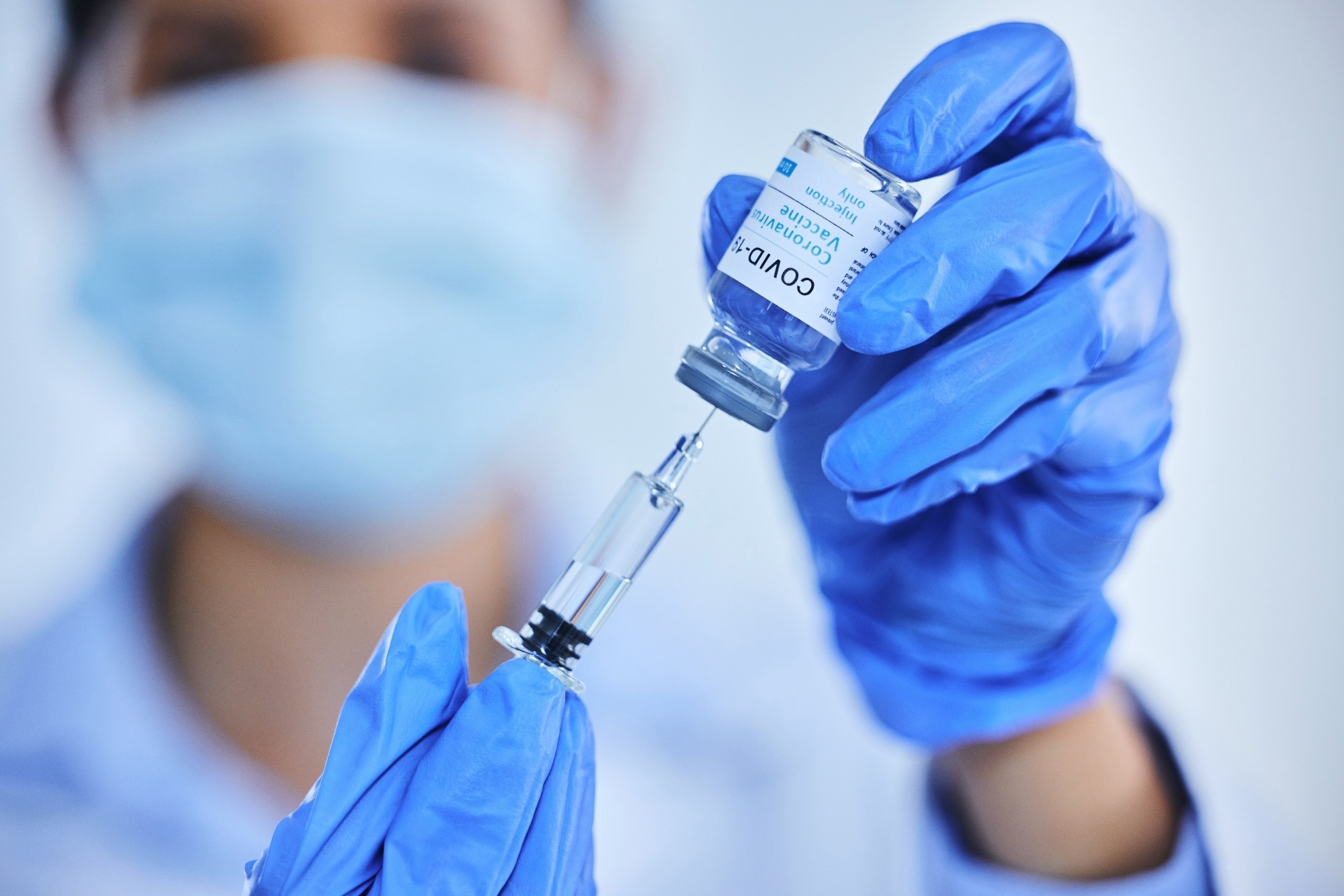 Person, hand and vaccine bottle with needle for treatment or control for virus, disease and liquid vial.