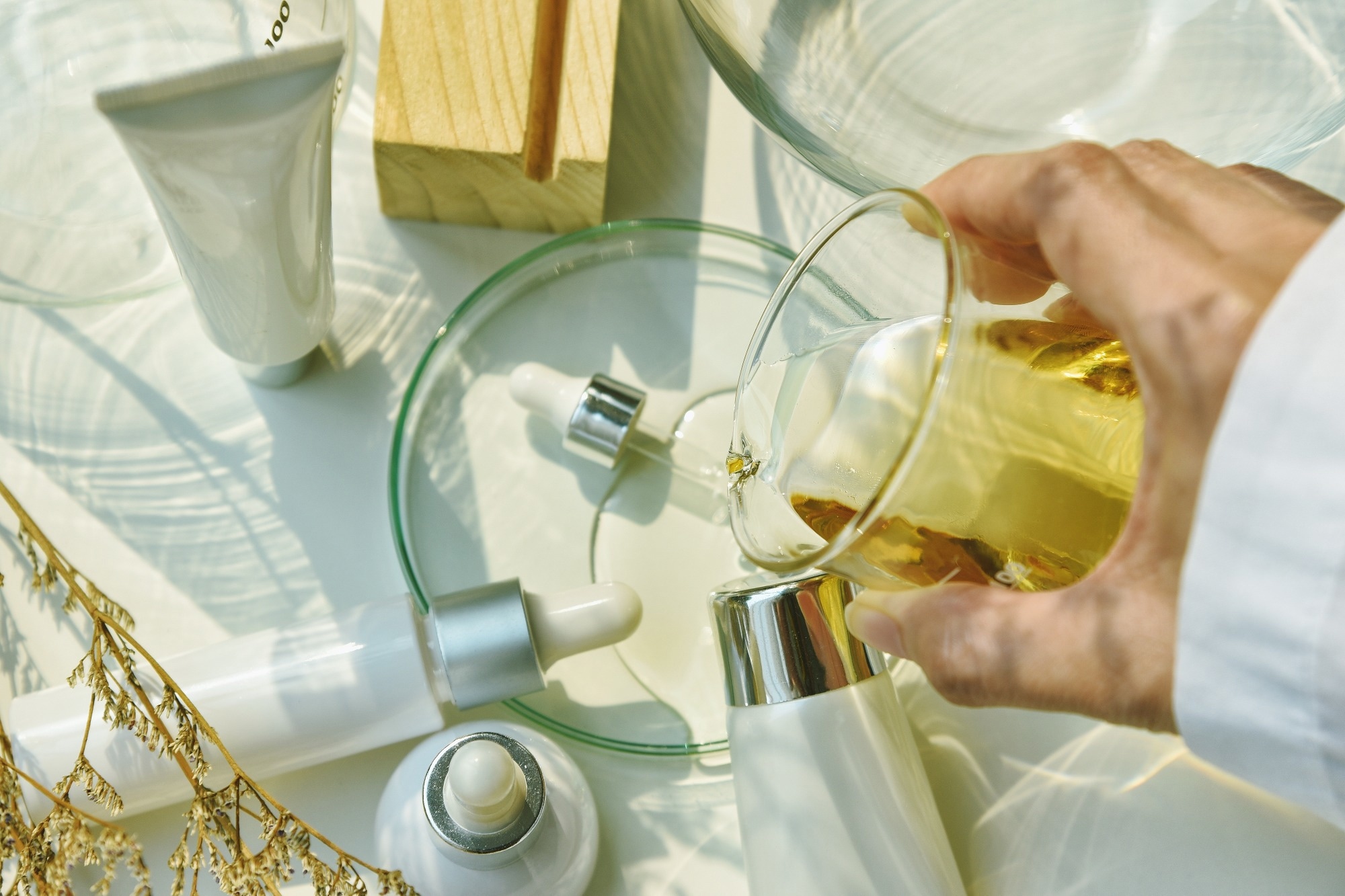 Scientist mixing natural skincare beauty products, Organic botany extraction and scientific laboratory glassware