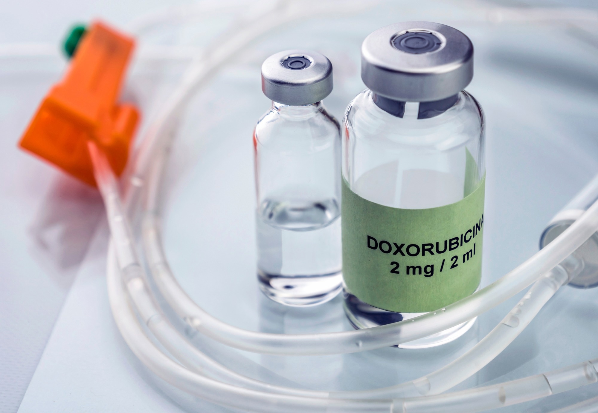 glass vials on table surrounded by medical tubes. One vial is labelled Doxorubicin