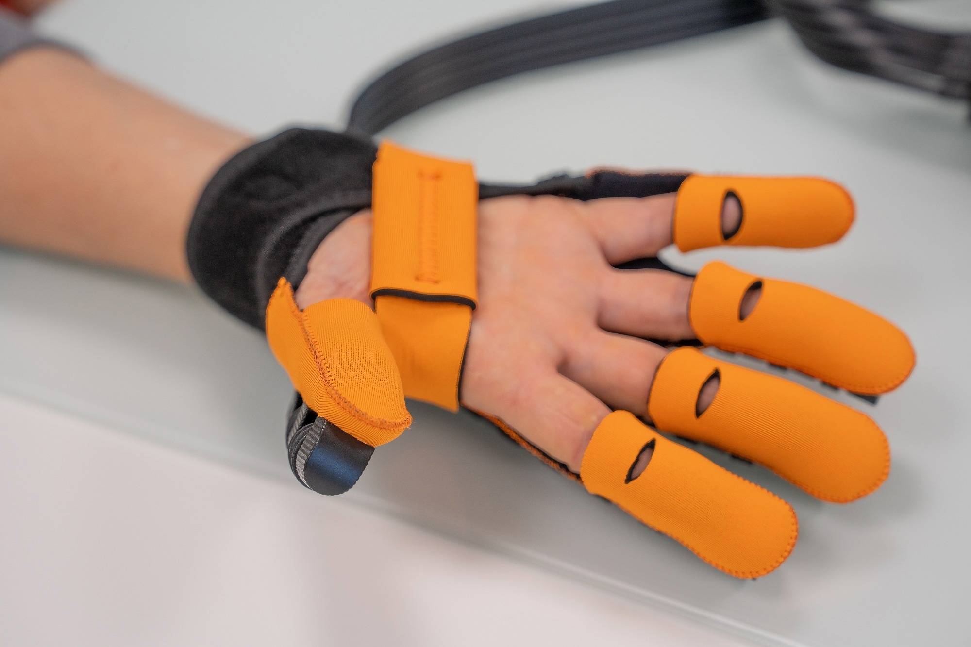 Glove rehabilitation with motor. Physiotherapy exercise for the human hand.