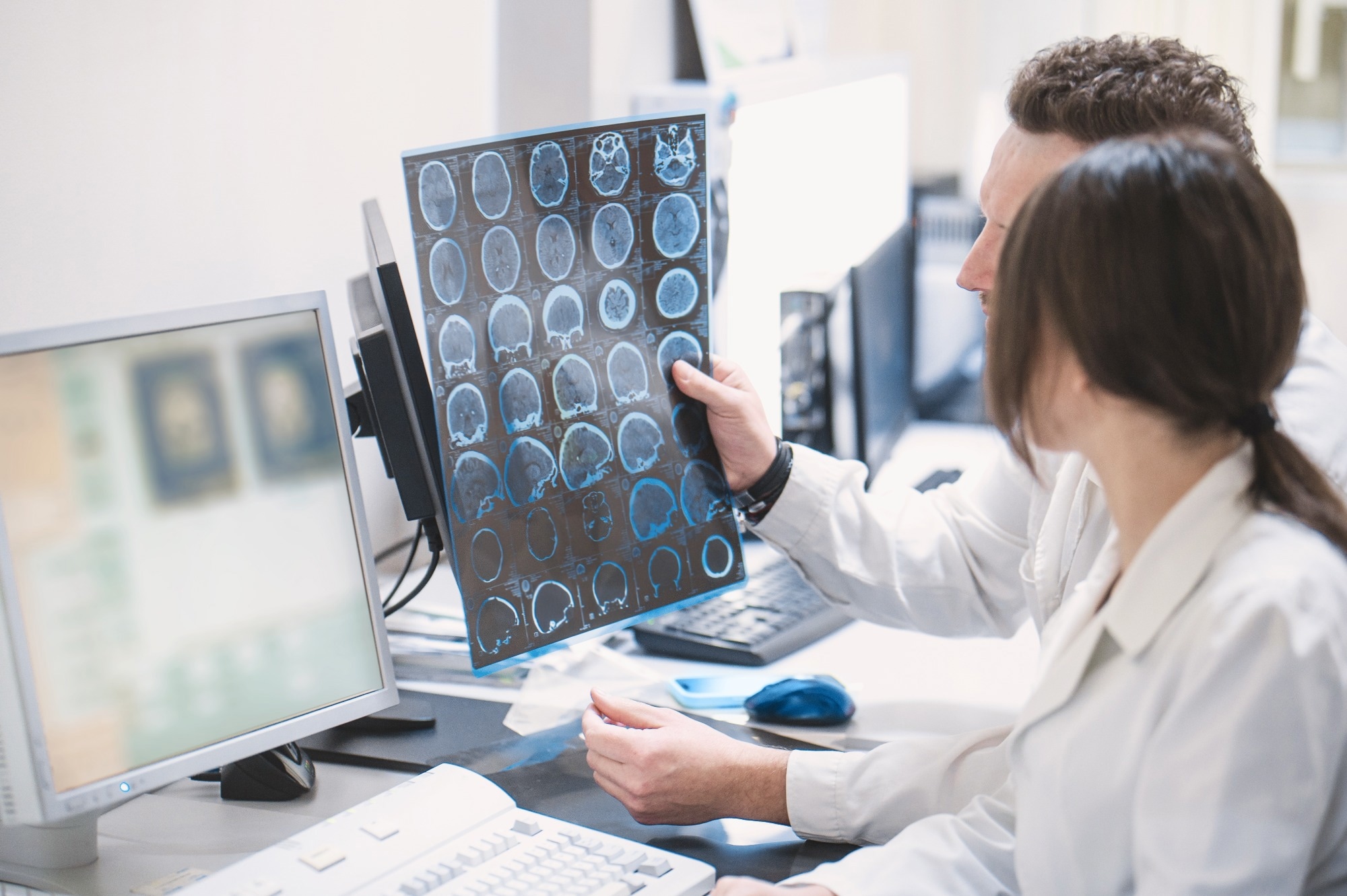 doctors looking at brain MRI scans in lab