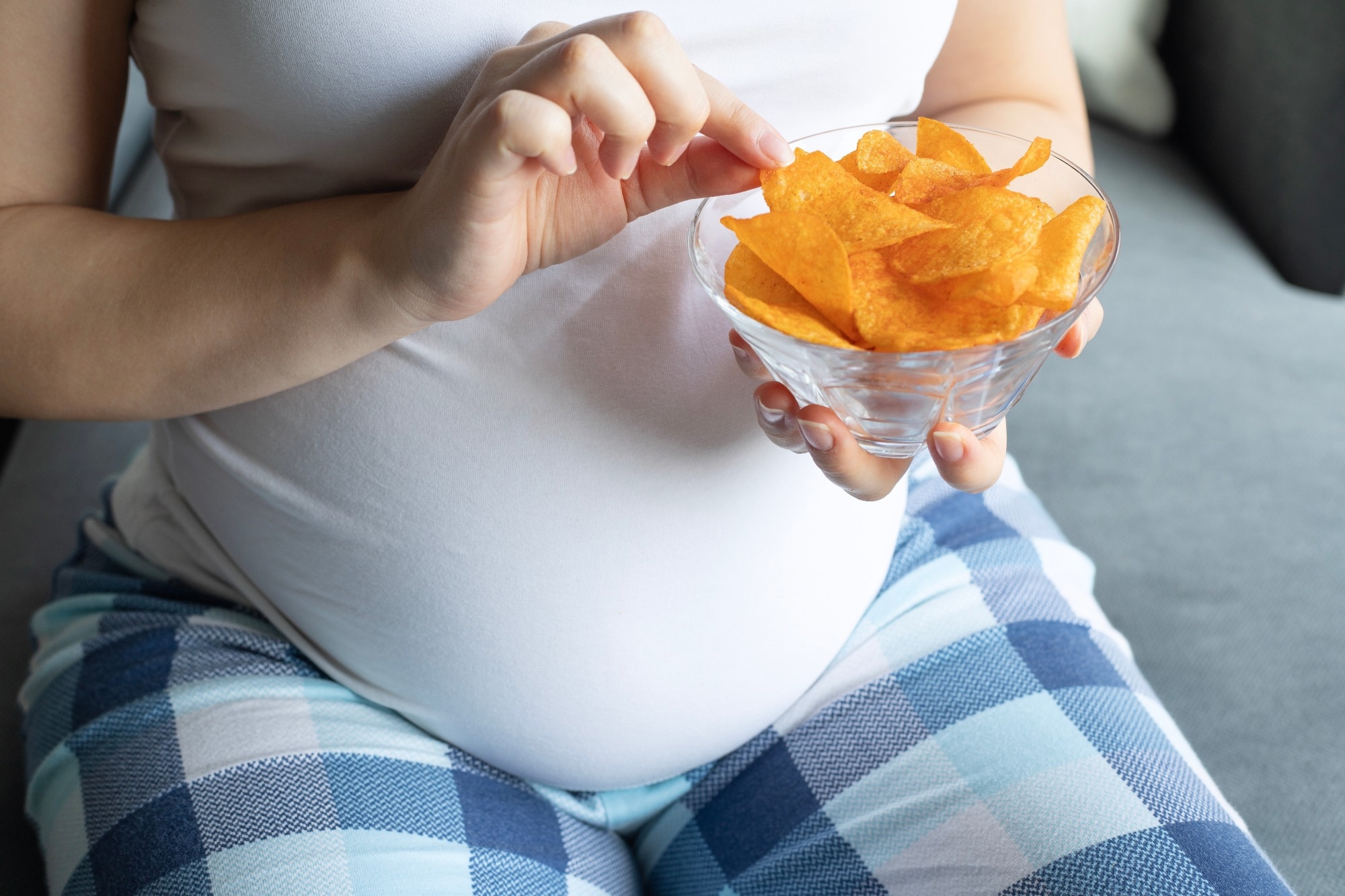pregnant woman eating crisps or chips