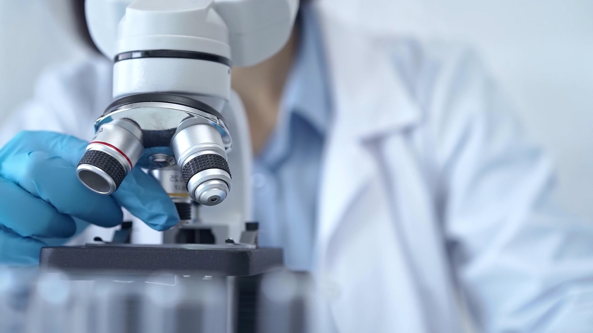 Scientist using microscope in laboratory.