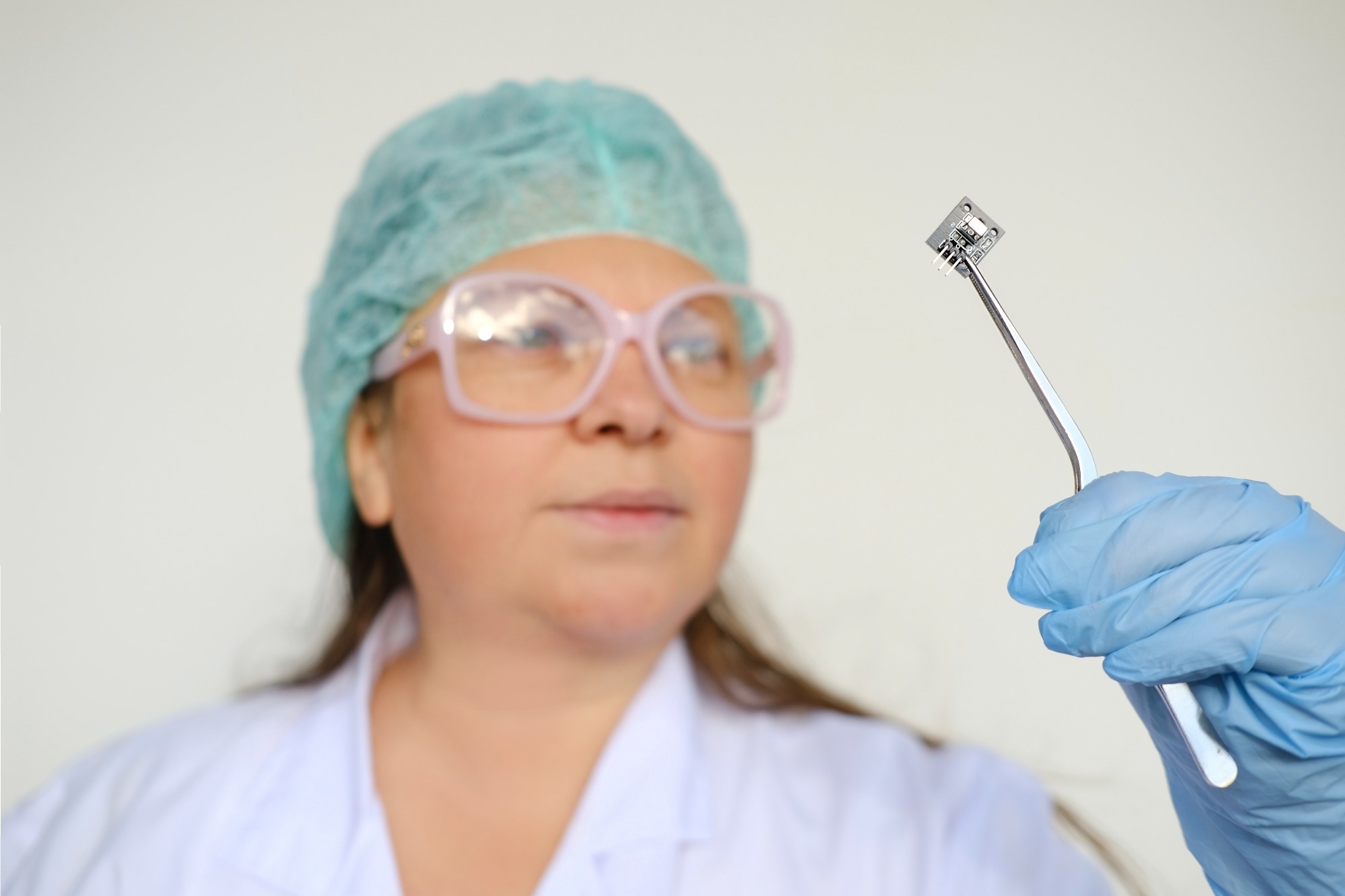 female scientist, doctor holding microprocessor.