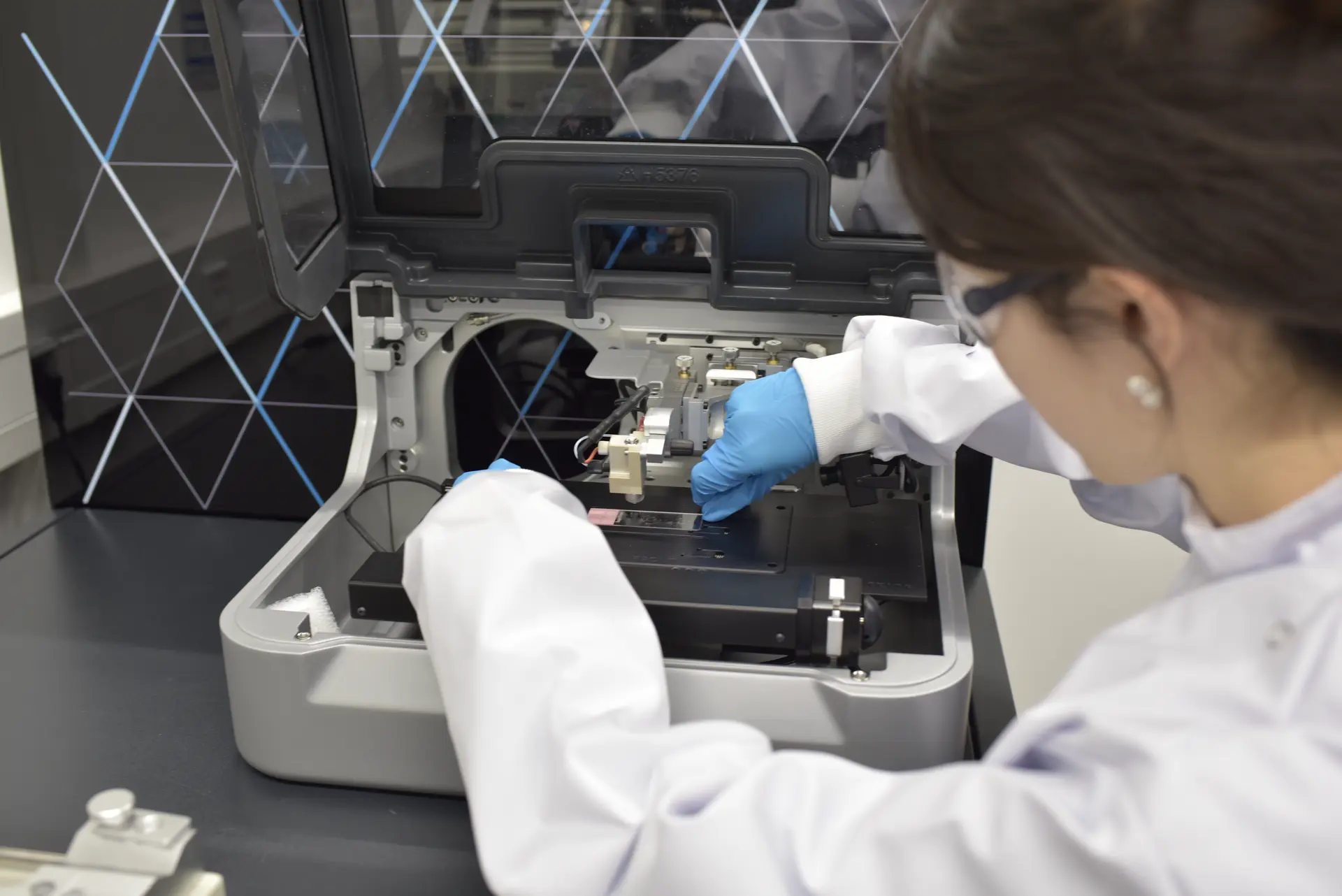 First author Wei Chen loads the mass spectrometer with a sample.