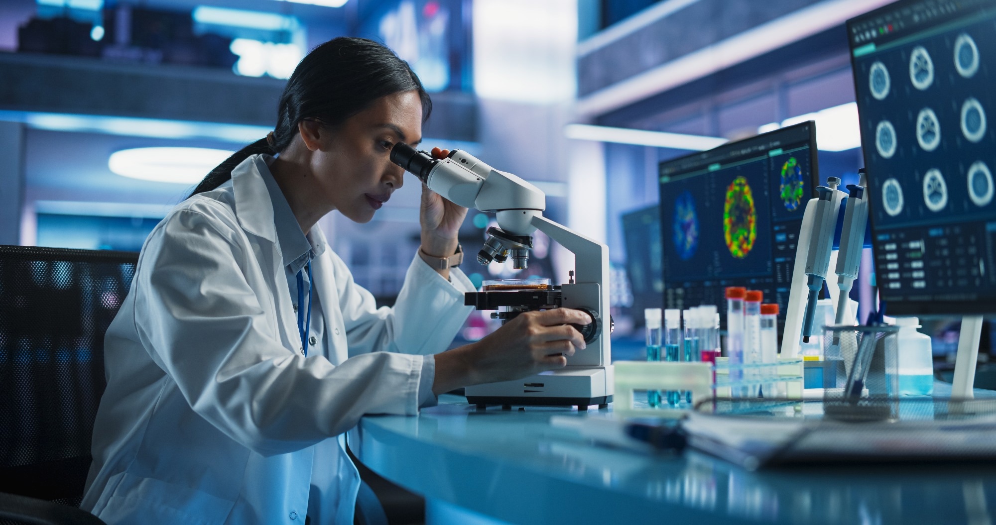 Scientist Using Microscope To Analyze Petri Dish Sample