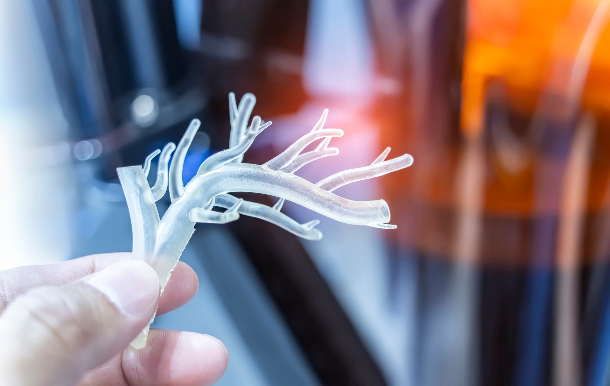 hand with object in shape of medically accurate a human blood vessel printed on 3d printer