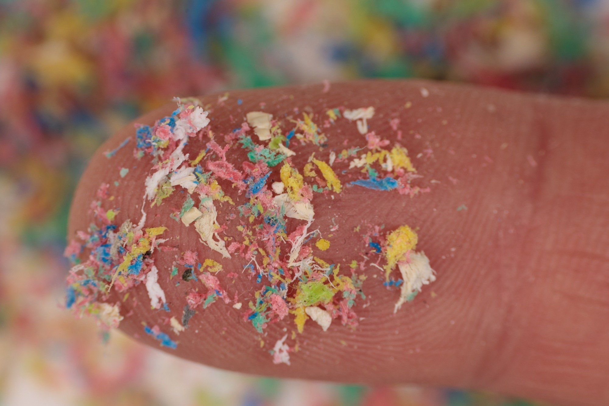 Close-up shot of microplastics on human fingers